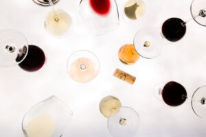 Viele verschiedenen Weingläser und Weine auf Glastischplatte Heribert Bayer